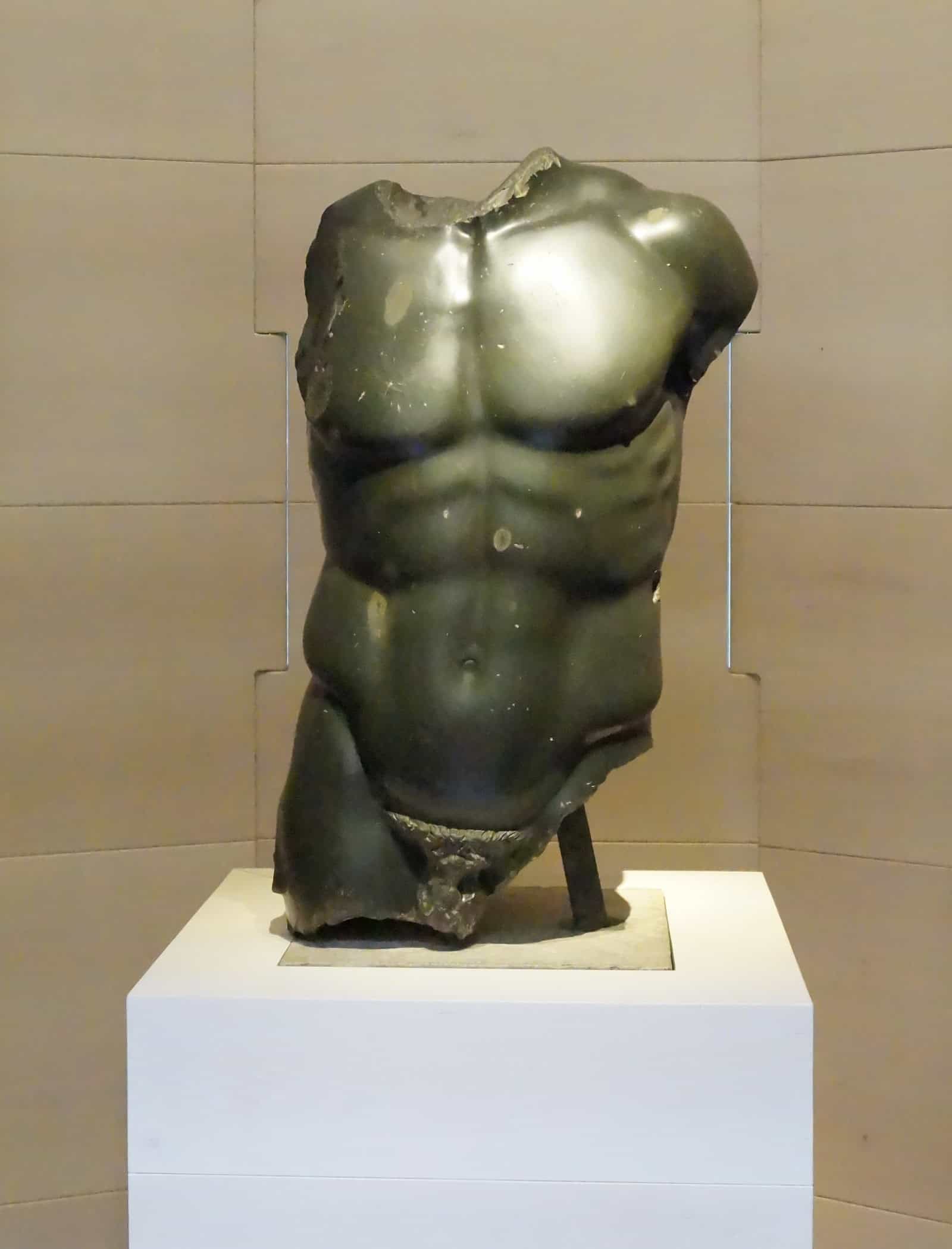 A Roman Doryphoros torso in dark basanite at the Uffizi Galleries.